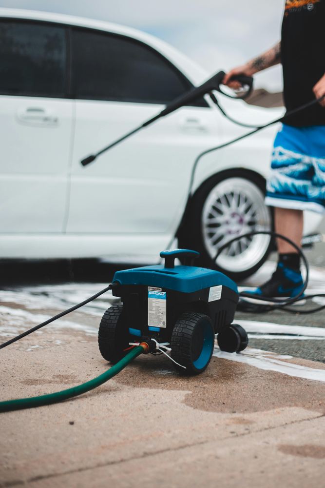 Pressure washing equipment cleaning an exterior hard surface