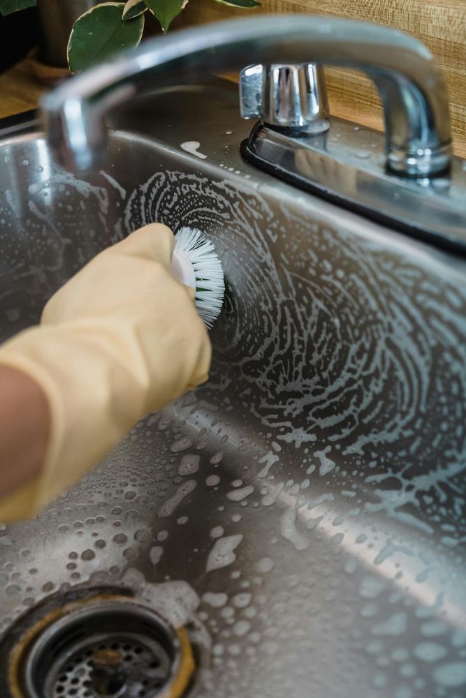 Detailed residential cleaning in a bright bathroom